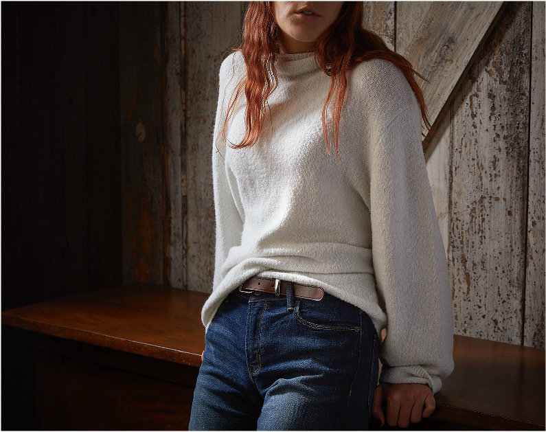 Woman in a white sweater and jeans