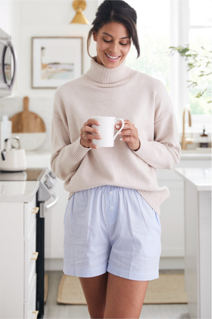 Woman in a sweater holding a mug