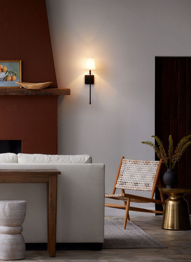 Living room with a wall sconce and a chair