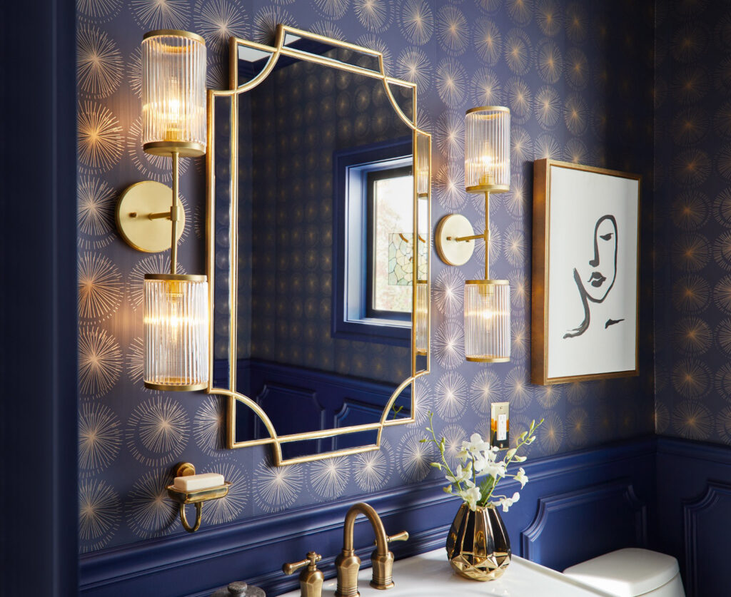 Bathroom with blue wallpaper and a lit mirror