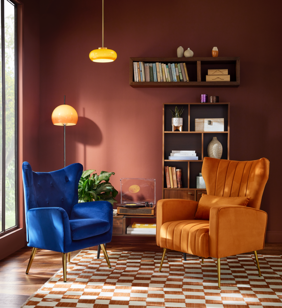 Living room with terracotta walls and velvet armchairs