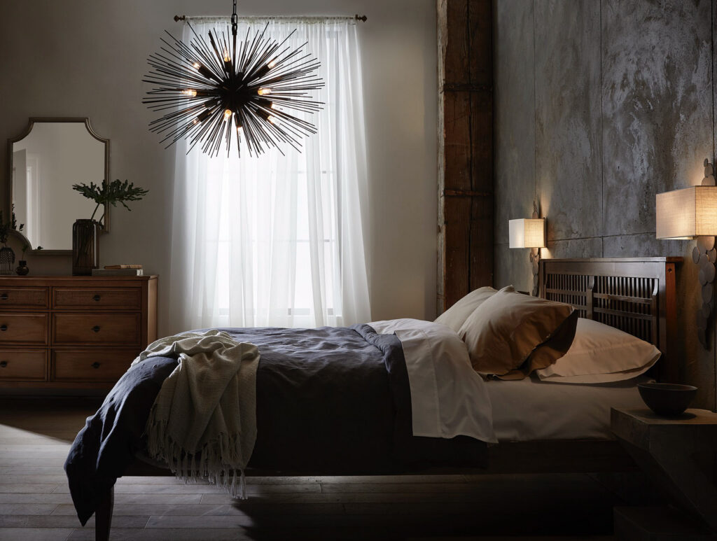 Bedroom with a starburst chandelier and dark decor