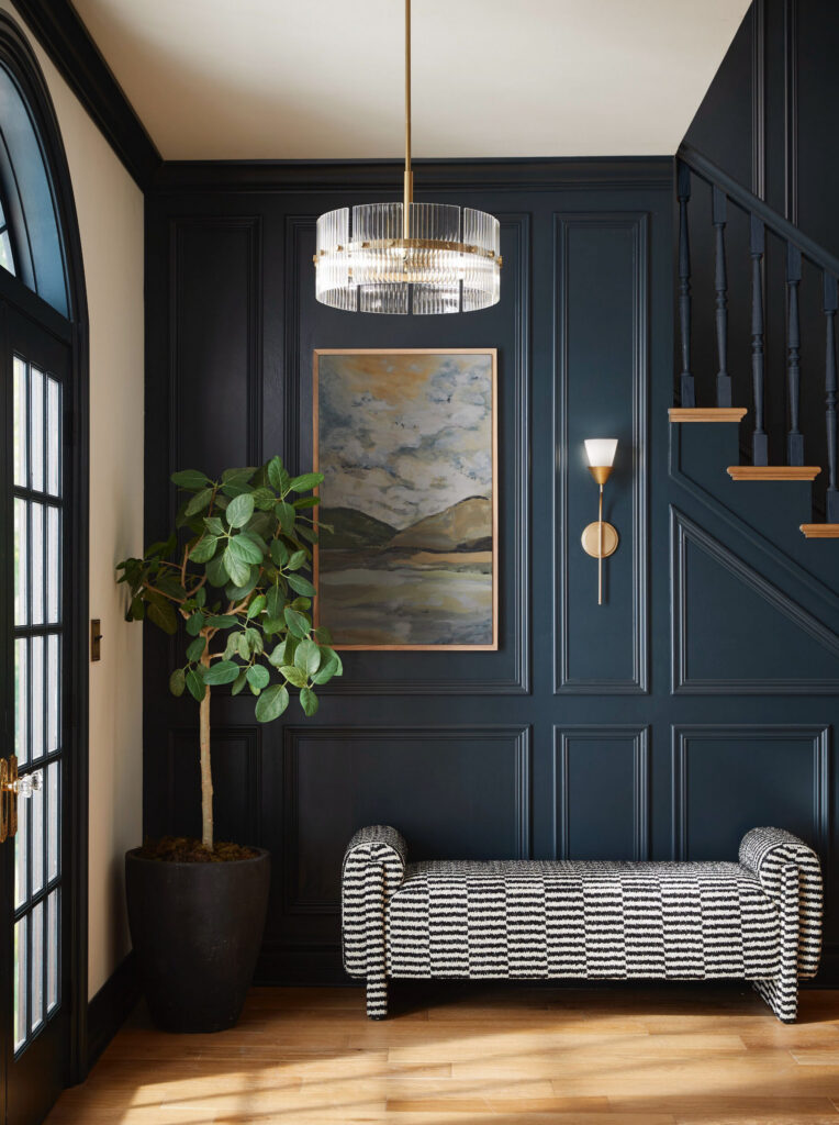 Hallway with dark blue walls and a pendant light