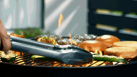 Grilling vegetables and buns on a barbecue