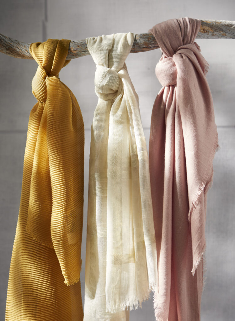 Scarves hanging in various colors