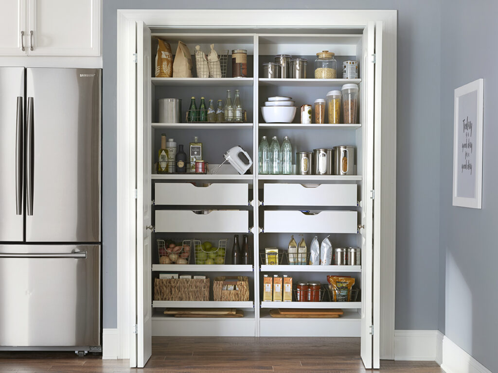 Stocked pantry next to a refrigerator
