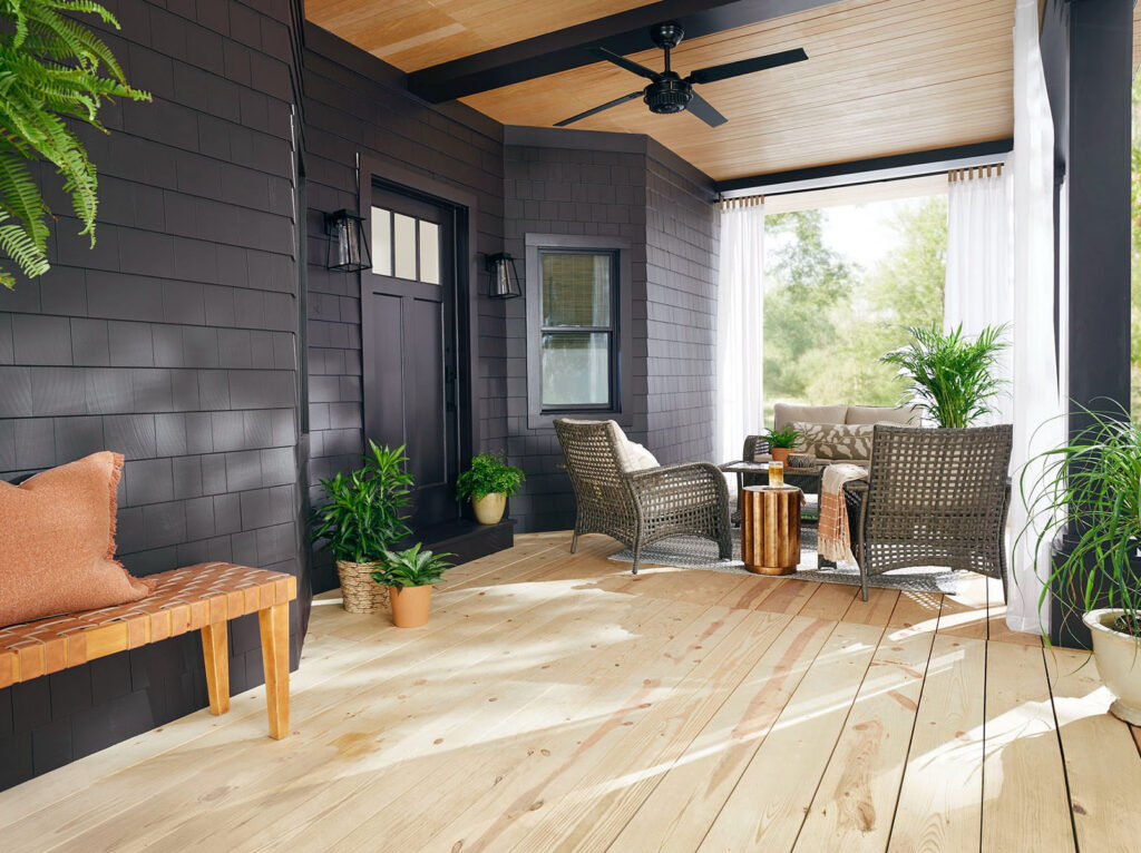 Patio with dark painted walls and a ceiling fan