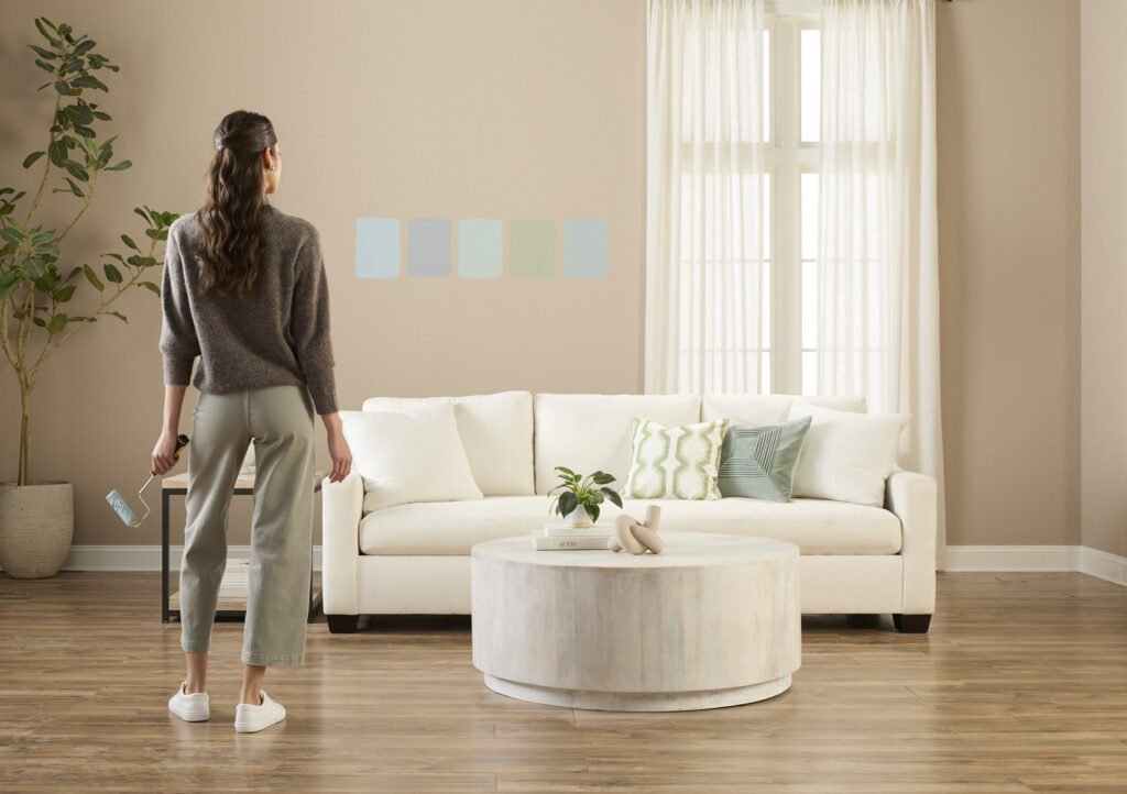 Woman looking at paint swatches in a living room