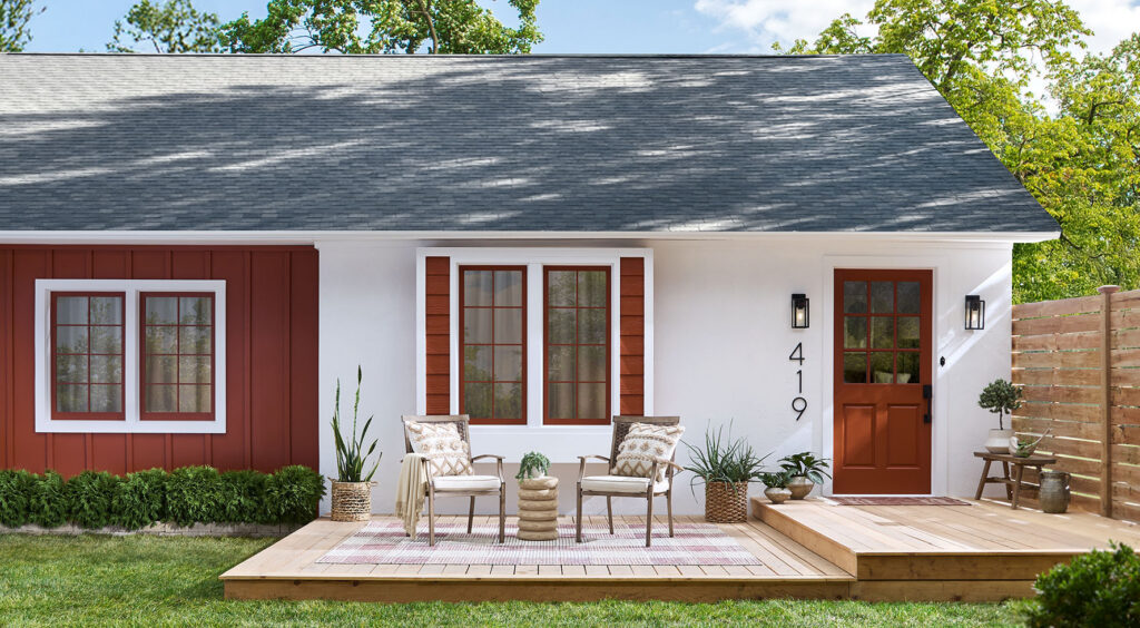 Red house exterior with a porch and patio furniture