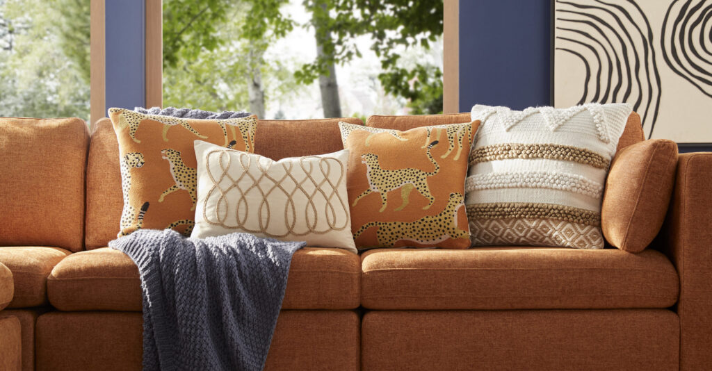 Brown sofa with decorative pillows and a throw blanket