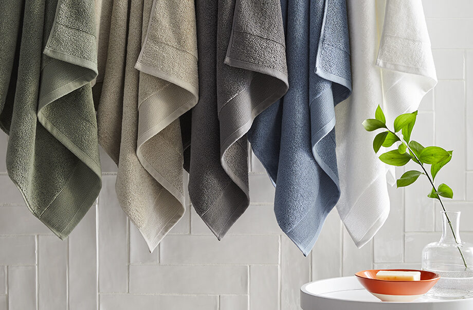 Towels in various colors hanging on a wall