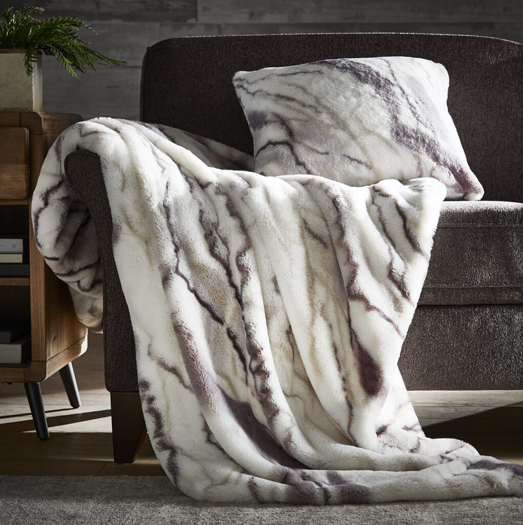 Faux fur throw blanket draped over a chair