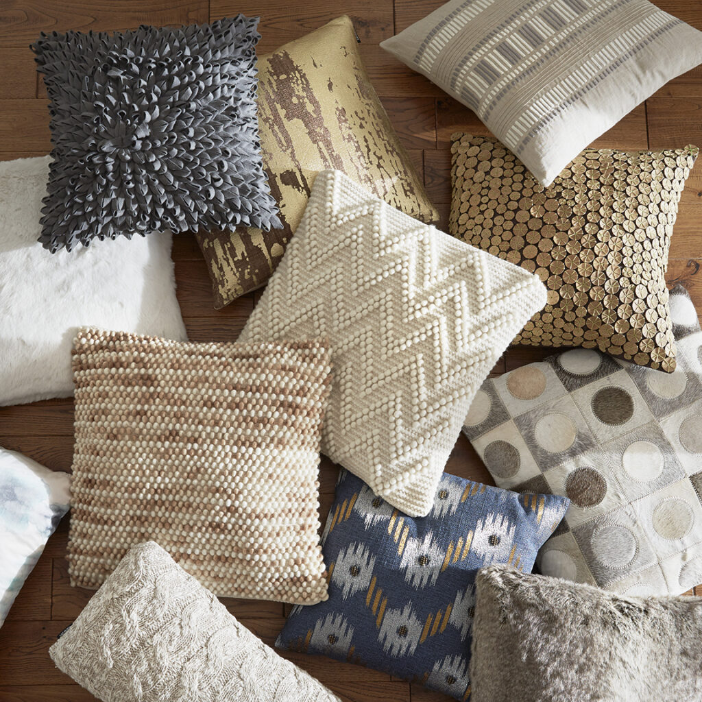 Pile of decorative throw pillows in various patterns