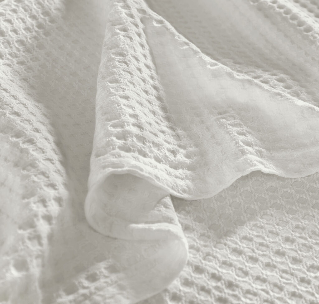 Close-up of a white textured knit blanket