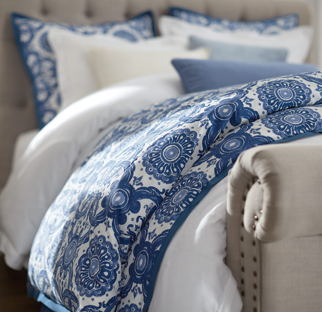 Bed with blue and white patterned bedding