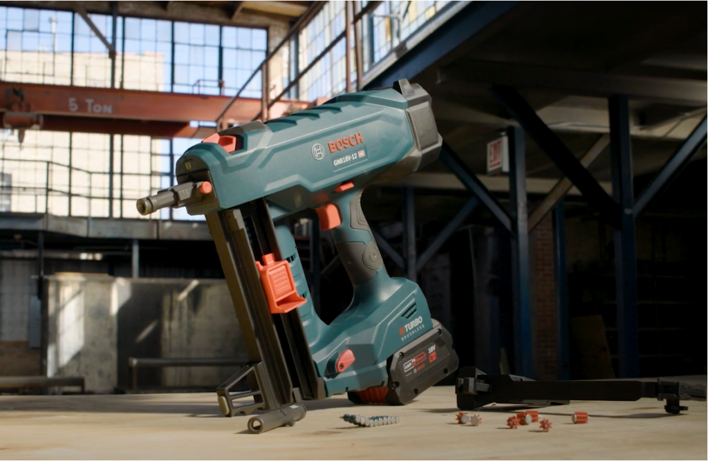 Cordless nail gun on a workbench at a construction site