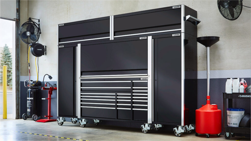 Garage with black tool storage cabinets and equipment
